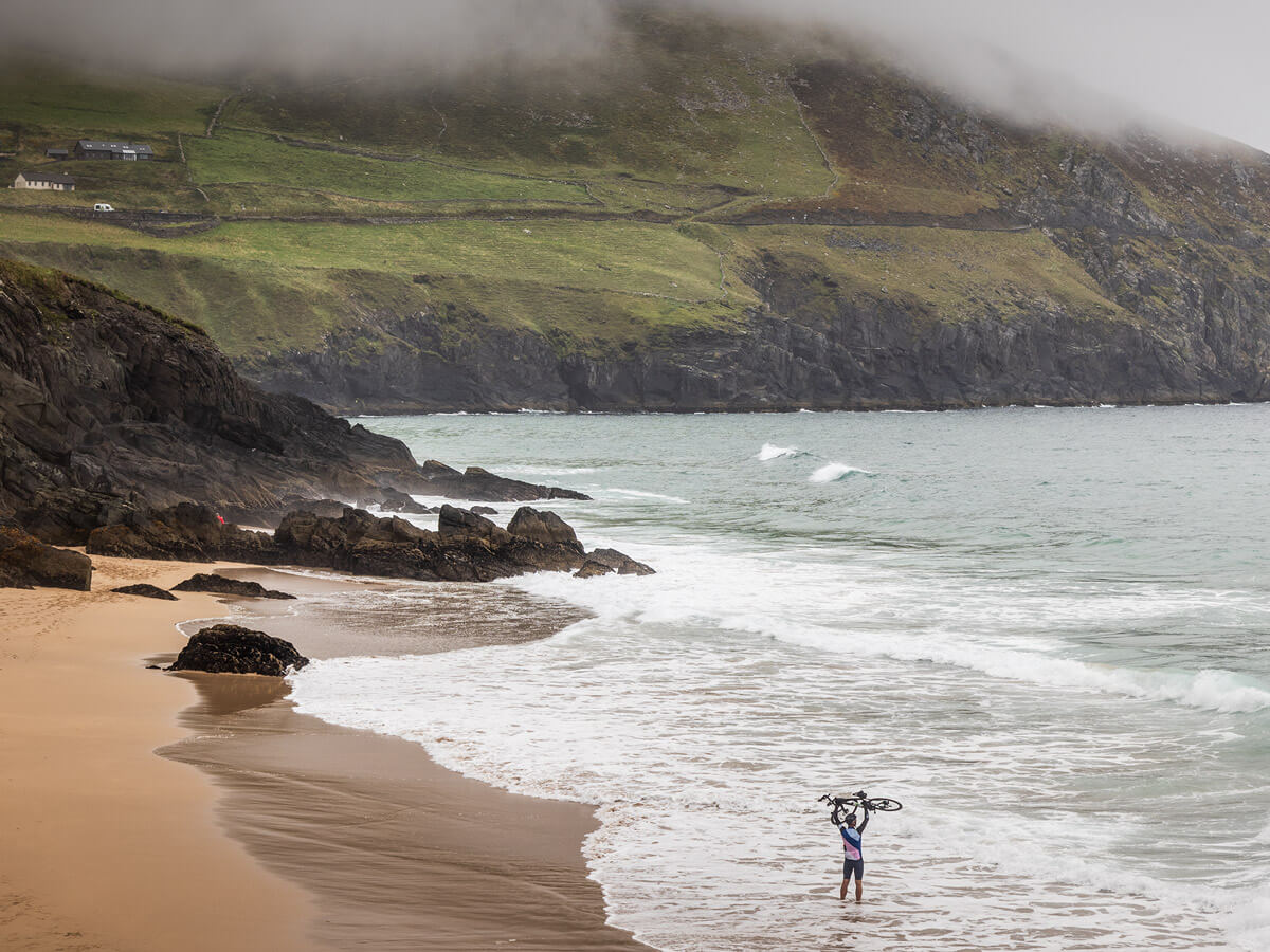 Rider standing on shoreline
